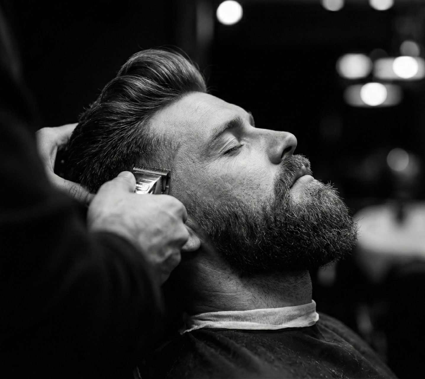 Barber detailing a client's fade with a trimmer